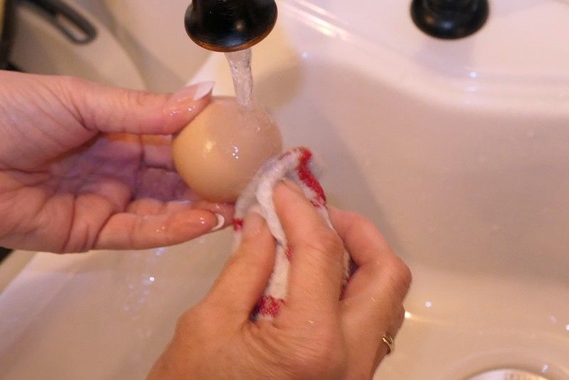 Washing a chicken egg